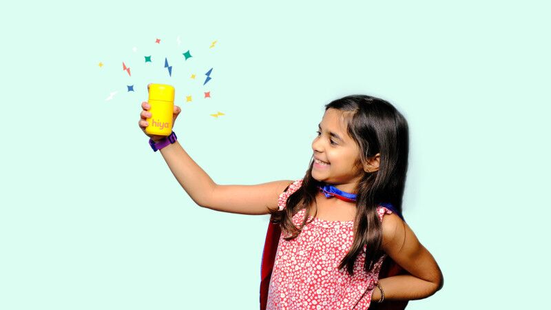 kid holding hiya vitamins